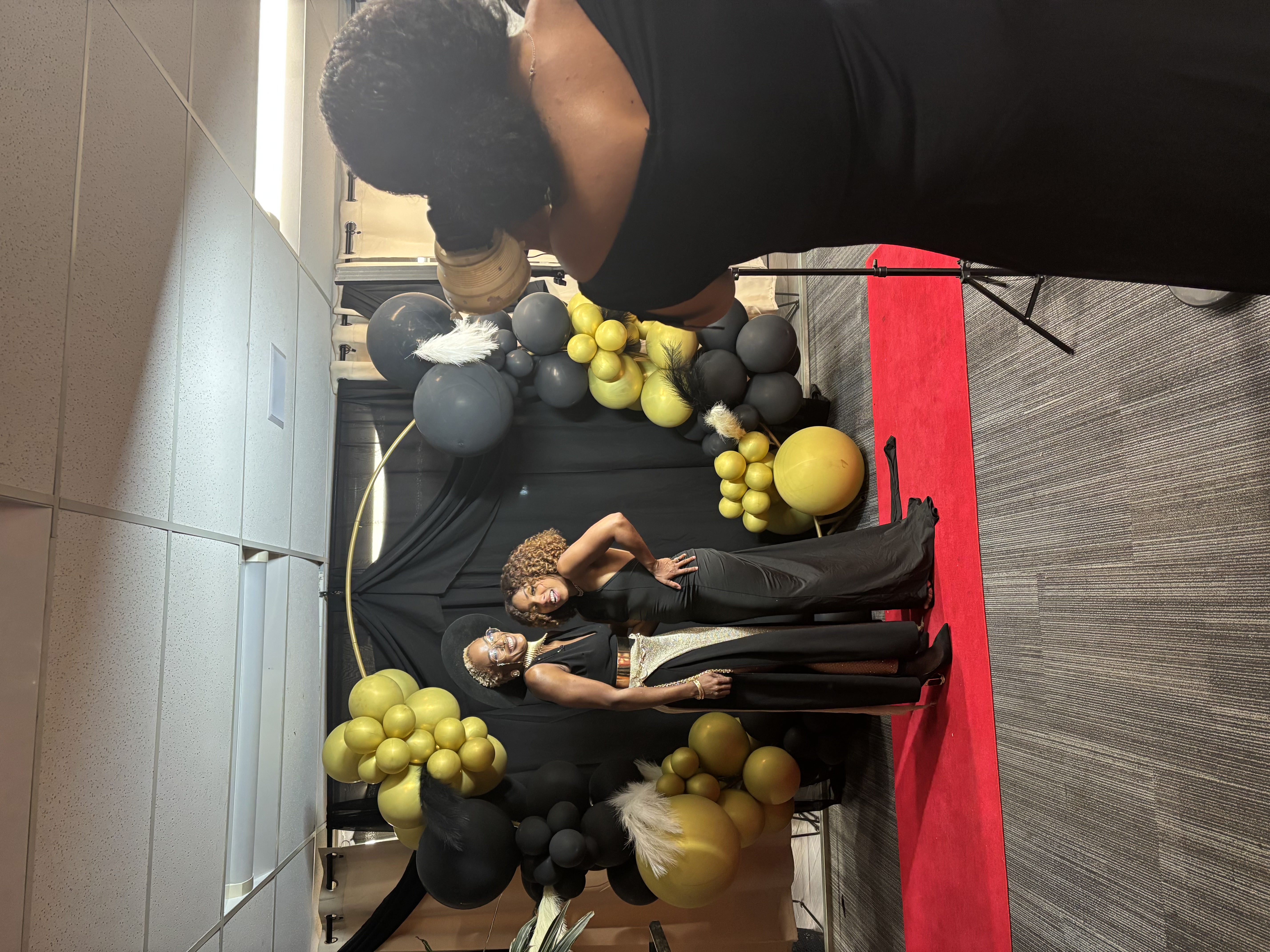 Red carpet VIP event with black and gold balloon backdrop Denver