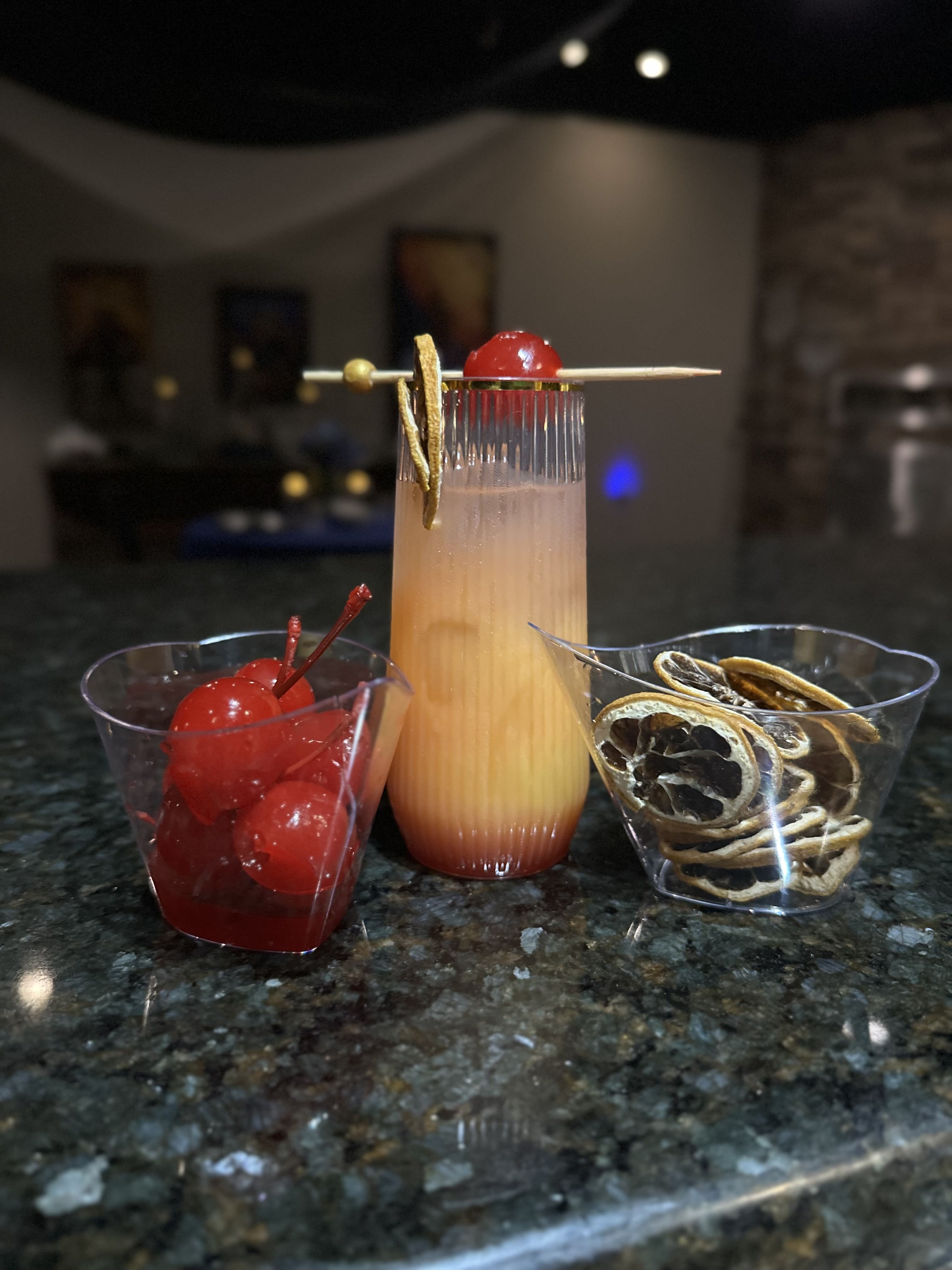 Artisan craft cocktail with cherry and citrus garnish