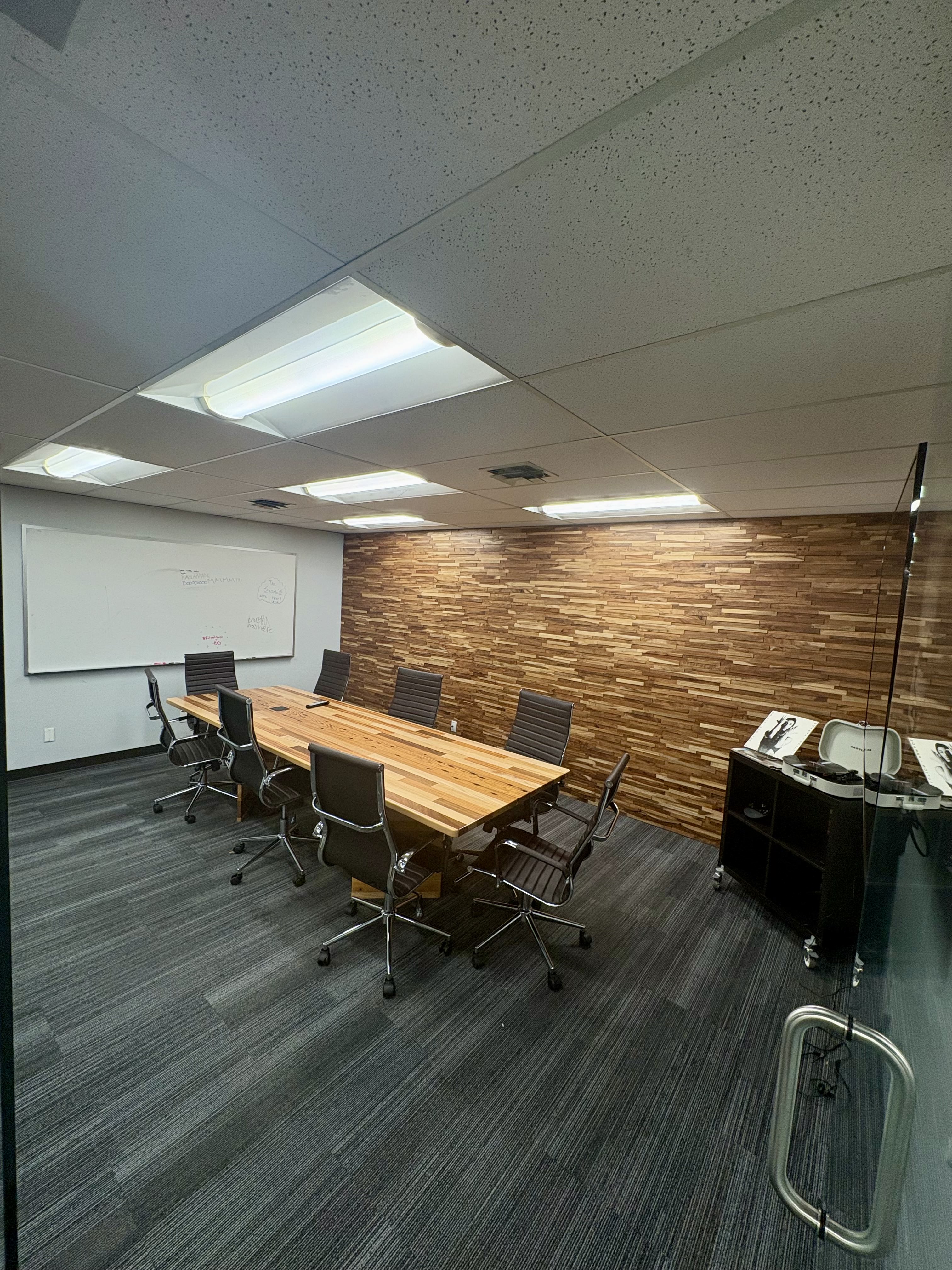 Professional boardroom conference room with wooden accent wall at Brown Rice Consortium Denver