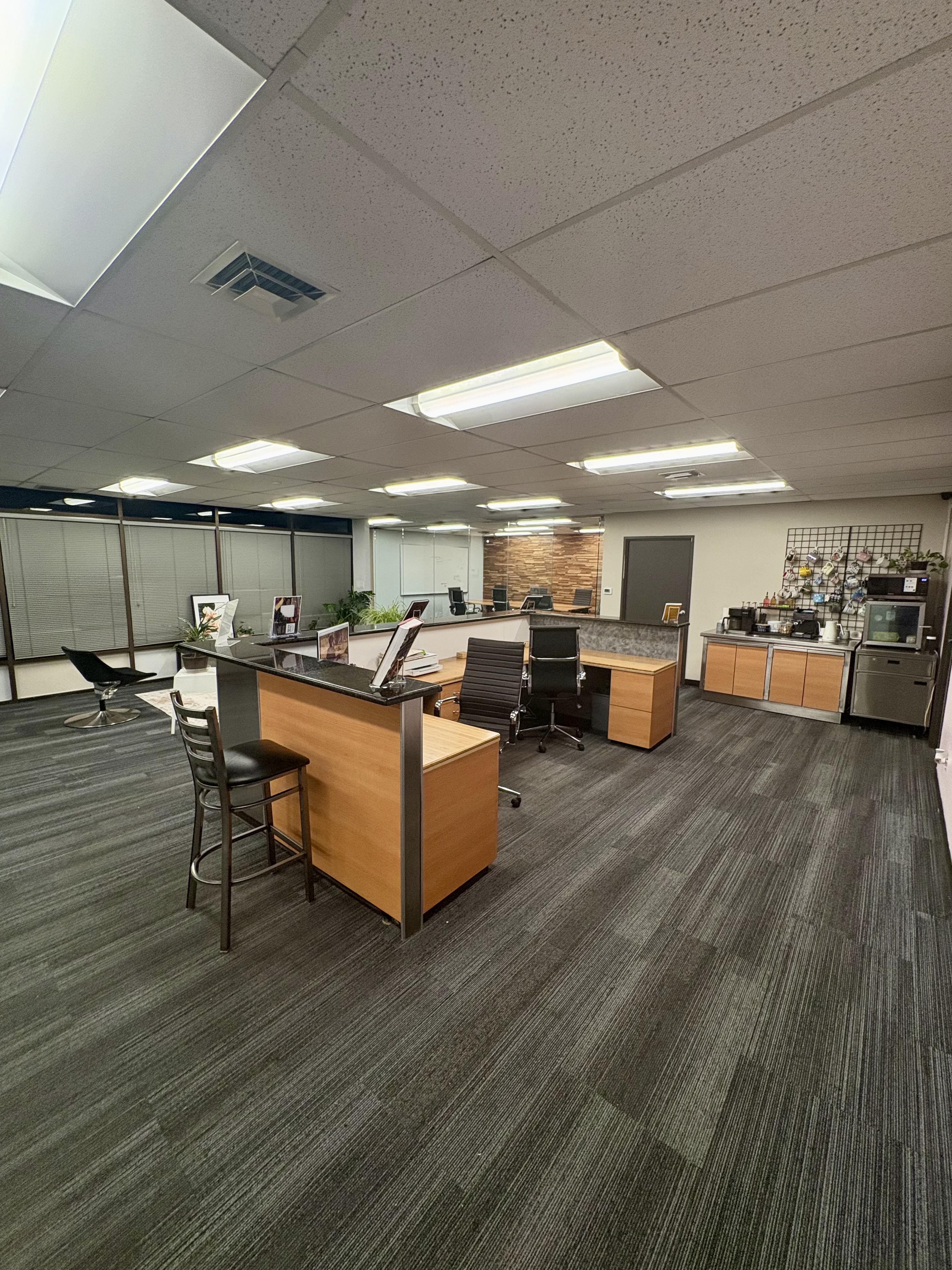 Open coworking workspace with desks and coffee station at Brown Rice Consortium Denver